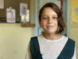 A girl from Scotland smiles.